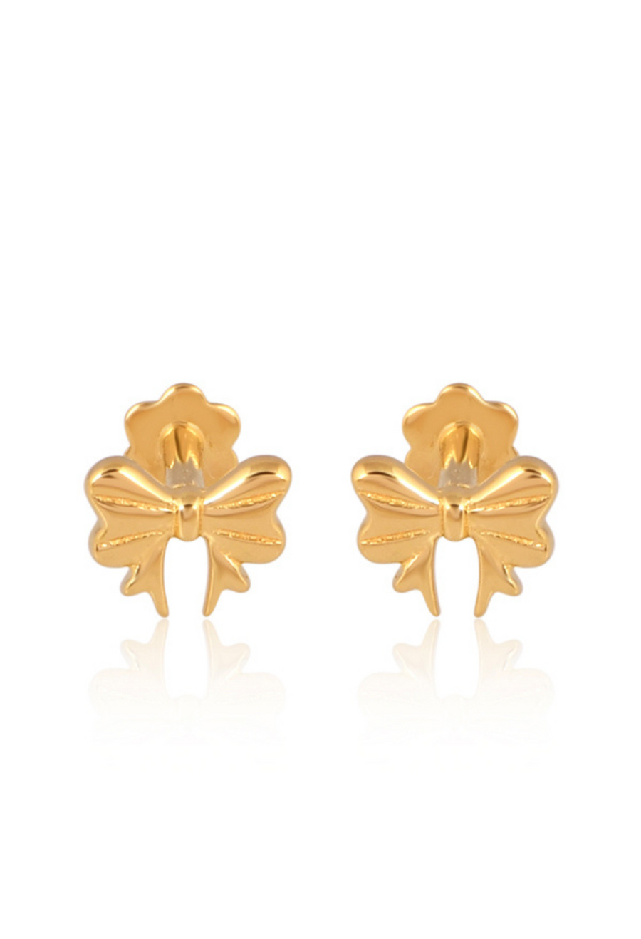 Gold bow-shaped earrings on a white background